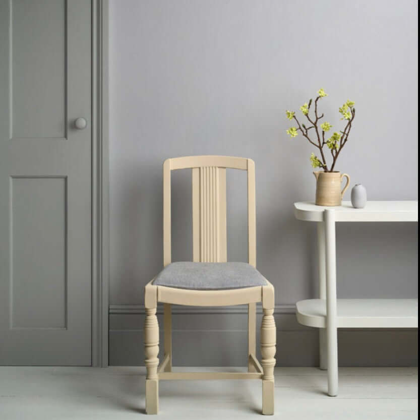 Chicago Grey - Annie Sloan Satin Paint used on a modern chair and wall, showcasing clean lines in a stylish interior.