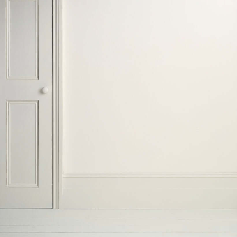 Interior view of a crisp white wall and door finished with Pure - Annie Sloan Satin Paint.